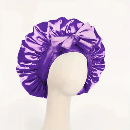 Purple satin hair bonnet with gathered crown and front tie bow for sleep