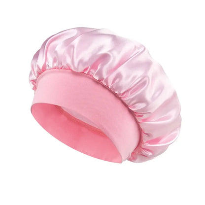 Satin sleeping hair bonnet, wide-brim style in pale pink with soft elastic band