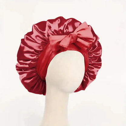Red satin bonnet with gathered ruffles, front bow tie, adjustable band