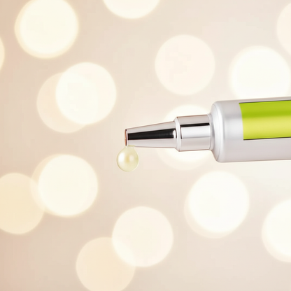 Serum dropper tip releasing pale gel drop from silver applicator with green label