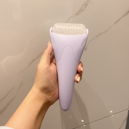 Purple facial ice roller with textured top, de-puffing cooling skin massager holder
