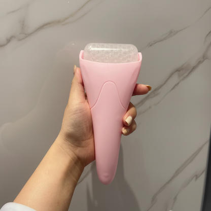 Pink facial ice roller with textured top, curved de-puffing cooling skin massager